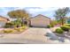 Single-story home featuring xeriscaped landscaping, two car garage, and an American flag at 1781 Cypress Lake Ct, Henderson, NV 89012