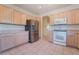 Kitchen with stainless steel refrigerator, light wood cabinets, and tile flooring at 1781 Cypress Lake Ct, Henderson, NV 89012