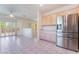 View of kitchen with dining area, stainless steel refrigerator, and tile floors at 1781 Cypress Lake Ct, Henderson, NV 89012