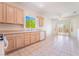 Kitchen with white dishwasher, light wood cabinets, and view to the dining room at 1781 Cypress Lake Ct, Henderson, NV 89012