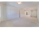 Spacious living room with neutral carpet, bright lighting, and an open floor plan at 1781 Cypress Lake Ct, Henderson, NV 89012