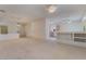 Open-concept living area with carpet and views to kitchen with breakfast bar at 1781 Cypress Lake Ct, Henderson, NV 89012