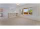 Bright living room with large windows, plantation shutters, and carpet at 1781 Cypress Lake Ct, Henderson, NV 89012