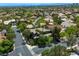 Beautiful aerial view of the neighborhood with mature trees, manicured lawns, and stunning Las Vegas skyline in the background at 2008 Winter Wind St, Las Vegas, NV 89134