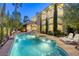 Inviting backyard featuring a sparkling pool, spa, lounge chairs, and a beautiful home exterior at 2008 Winter Wind St, Las Vegas, NV 89134