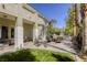 Spacious backyard featuring a covered patio, fire pit seating, and lush green grass at 2008 Winter Wind St, Las Vegas, NV 89134