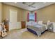 Bedroom features a corner window, guitar, and ceiling fan at 2008 Winter Wind St, Las Vegas, NV 89134