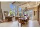 Open-concept dining area boasts a view of the living room's floor-to-ceiling windows and staircase at 2008 Winter Wind St, Las Vegas, NV 89134