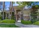 Inviting entrance with mature trees and stone accents that enhances the curb appeal of the property at 2008 Winter Wind St, Las Vegas, NV 89134