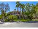 Stunning two-story home featuring mature landscaping, palm trees and lush green grass at 2008 Winter Wind St, Las Vegas, NV 89134