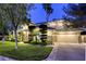 Beautiful home with a well-manicured lawn, mature trees, and a three car garage at 2008 Winter Wind St, Las Vegas, NV 89134