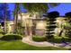 Charming home featuring lush landscaping, a stone accent wall, and a walkway to the front door at 2008 Winter Wind St, Las Vegas, NV 89134