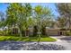 Beautiful home with a well-manicured lawn, mature trees, and a three car garage at 2008 Winter Wind St, Las Vegas, NV 89134