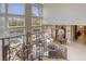 The grand living room overlooks the pool through large windows, as seen from the staircase at 2008 Winter Wind St, Las Vegas, NV 89134