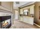 Living room featuring a fireplace, a kitchenette, and neutral colored walls at 2008 Winter Wind St, Las Vegas, NV 89134