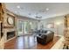 Bright living room boasts a fireplace, hardwood floors, and multiple windows with view to the backyard at 2008 Winter Wind St, Las Vegas, NV 89134