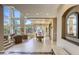 The open-concept living area features large windows, a staircase, and seamless flow to the dining area at 2008 Winter Wind St, Las Vegas, NV 89134