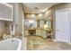 Charming bathroom with a vanity area, soaking tub, and decorative accents at 2008 Winter Wind St, Las Vegas, NV 89134