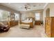 Spacious main bedroom with natural light, carpet floors, and wooden furniture at 2008 Winter Wind St, Las Vegas, NV 89134