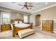 Elegant main bedroom features a wood bed frame, ceiling fan, and two bedside tables at 2008 Winter Wind St, Las Vegas, NV 89134