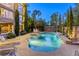 Sparkling backyard pool with spa and waterfall feature surrounded by lush greenery and lounge chairs at 2008 Winter Wind St, Las Vegas, NV 89134
