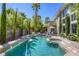 Backyard pool features a hot tub and waterfall in a private setting at 2008 Winter Wind St, Las Vegas, NV 89134