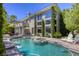 Outdoor pool with hot tub and patio area surrounded by lush landscaping at 2008 Winter Wind St, Las Vegas, NV 89134