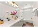 Bathroom with double sinks, modern fixtures, wood floors, and a shower over tub combination at 215 Sunlight Peak St, Henderson, NV 89012