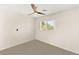 Bedroom with neutral carpet, ceiling fan, and a window for natural light, creating a serene space at 215 Sunlight Peak St, Henderson, NV 89012