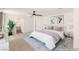 Staged bedroom features a large bed, neutral tones, and an ensuite bathroom for convenience at 215 Sunlight Peak St, Henderson, NV 89012
