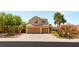 Charming two-story home with a two-car garage, well-manicured landscaping, and a classic Southwest design at 215 Sunlight Peak St, Henderson, NV 89012