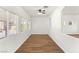 Bright living room with wood floors, ample windows, and ceiling fan at 215 Sunlight Peak St, Henderson, NV 89012