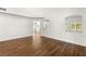 A brightly lit living room with beautiful wood floors and an arched doorway to another room at 215 Sunlight Peak St, Henderson, NV 89012