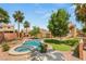 Backyard oasis features a sparkling pool, spa, lush landscaping, and mature trees for privacy at 215 Sunlight Peak St, Henderson, NV 89012