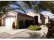 Charming single-story home featuring a well-maintained front yard with desert landscaping and mature trees at 2156 Eagle Sticks Dr, Henderson, NV 89012