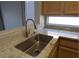 Close-up of the kitchen sink featuring granite countertops, stainless steel sink, and modern faucet at 2156 Eagle Sticks Dr, Henderson, NV 89012