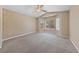 Spacious main bedroom featuring plush carpet flooring, a ceiling fan, and a bay window at 2156 Eagle Sticks Dr, Henderson, NV 89012