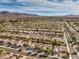 Scenic aerial view showing the community with well-kept homes against a backdrop of distant mountains at 2581 Terrytown Ave, Henderson, NV 89052