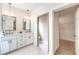 Bright bathroom boasts double vanity, marble countertops, modern fixtures and walk-in closet through an open doorway at 2581 Terrytown Ave, Henderson, NV 89052