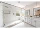 Luxurious bathroom with glass shower, marble tile, double vanity with modern fixtures, and recessed lighting at 2581 Terrytown Ave, Henderson, NV 89052