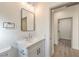 Modern bathroom featuring marble-look vanity with modern fixtures, ample lighting, and an adjacent room at 2581 Terrytown Ave, Henderson, NV 89052