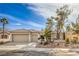Single-story home featuring desert landscaping, a tile roof, and a three car garage at 2581 Terrytown Ave, Henderson, NV 89052