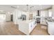 Bright, open kitchen features a waterfall island, stainless steel appliances, and modern finishes at 2581 Terrytown Ave, Henderson, NV 89052
