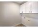 Utility room has overhead cabinet storage, connections for a washer and dryer, and minimalist design at 2581 Terrytown Ave, Henderson, NV 89052