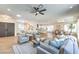 Open concept living space with a ceiling fan, neutral decor, and wood-look floors at 2581 Terrytown Ave, Henderson, NV 89052