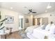 Bright bedroom features accent wall and decor, ceiling fan, access to en suite bathroom, and view of walk-in closet at 2581 Terrytown Ave, Henderson, NV 89052