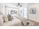 Bright bedroom features a large bed, plenty of windows, views of backyard, and a door to main bath at 2581 Terrytown Ave, Henderson, NV 89052