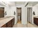 Bright bathroom boasts granite counters, a mirrored closet, and a view of the toilet and bath at 2606 S Durango Dr # 276, Las Vegas, NV 89117