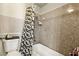 Cozy bathroom with unique shower and bathtub combination featuring patterned wall tiles at 2606 S Durango Dr # 276, Las Vegas, NV 89117