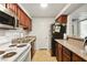 Efficient kitchen layout with classic cabinets, granite countertops, and essential appliances at 2606 S Durango Dr # 276, Las Vegas, NV 89117